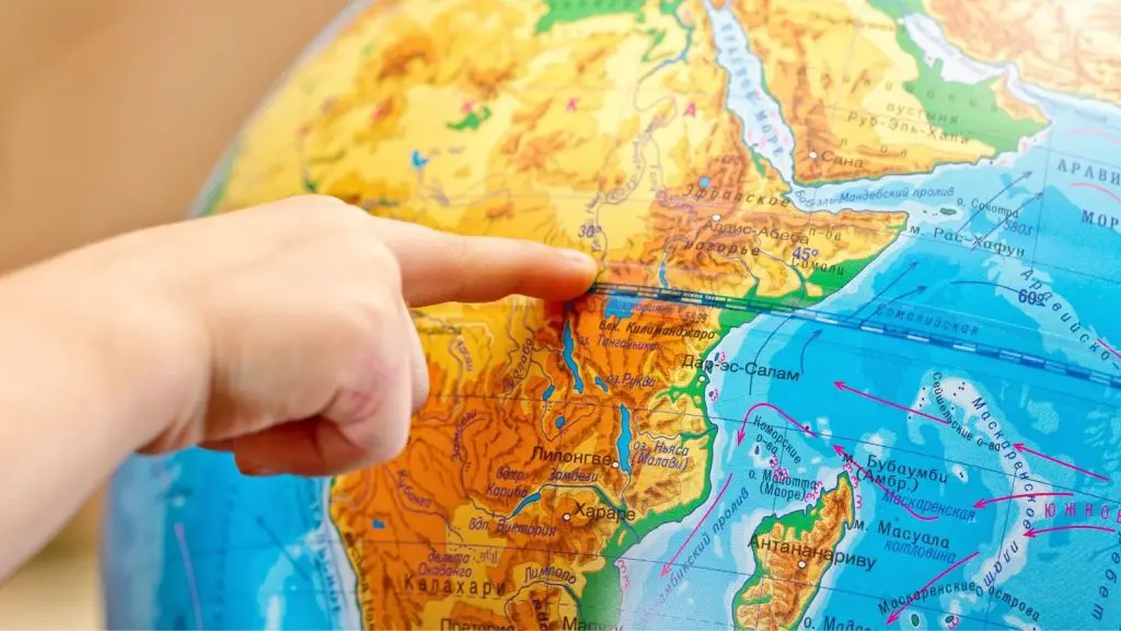 finger pointing on the globe