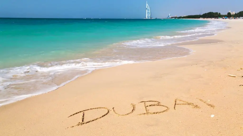 Dubai written on a beach