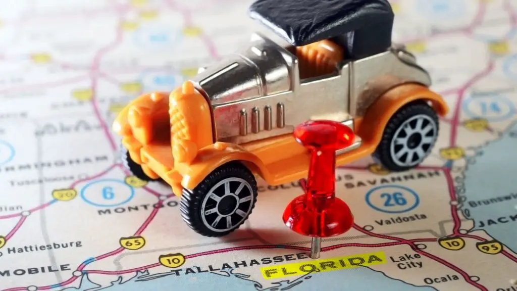 Florida pinned on map and toy car on the map