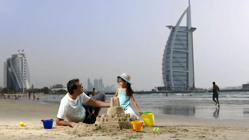 father and daughter enjoying beach in Dubai